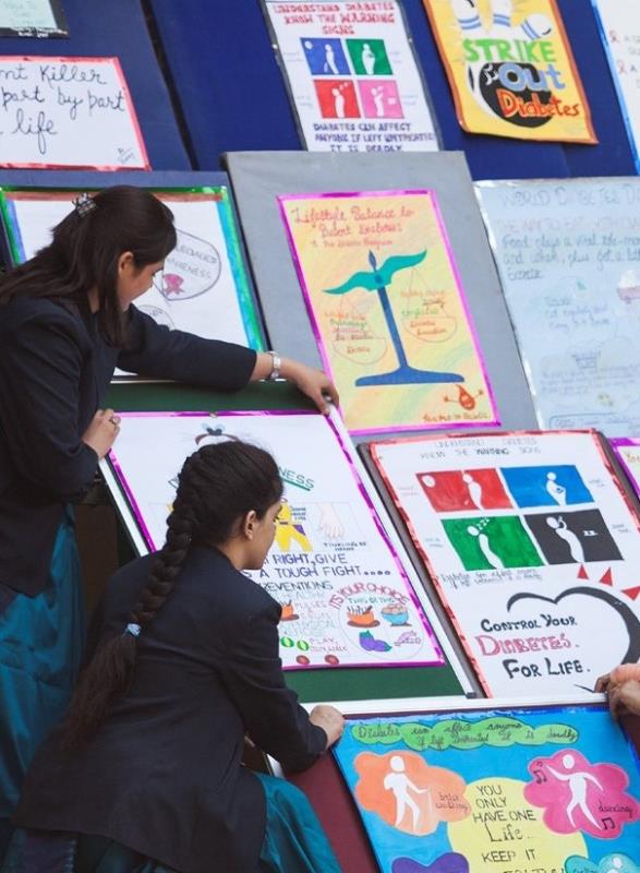 Students displaying their posters